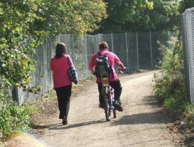 Students cycling alongside new fencing